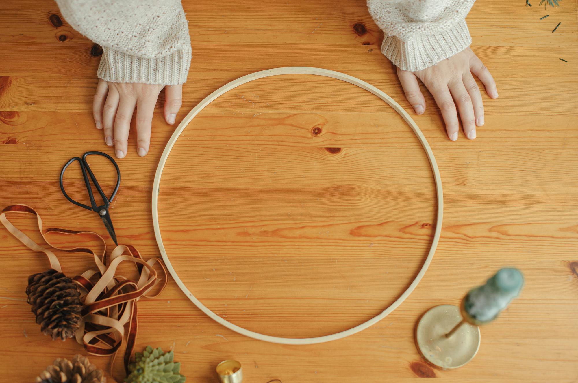 Workspace with hoops and threads on table